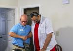 David Michael, the Executive Director of Huntington WV Area Habitat for Humanity, presents Brian Holland with the keys to his new home.