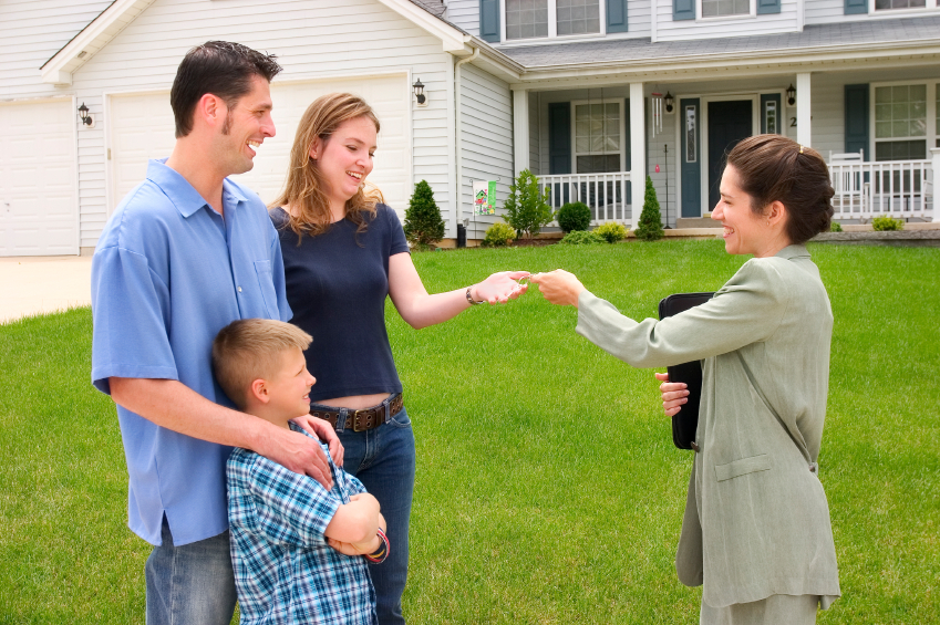 Realtor giving family keys to new home