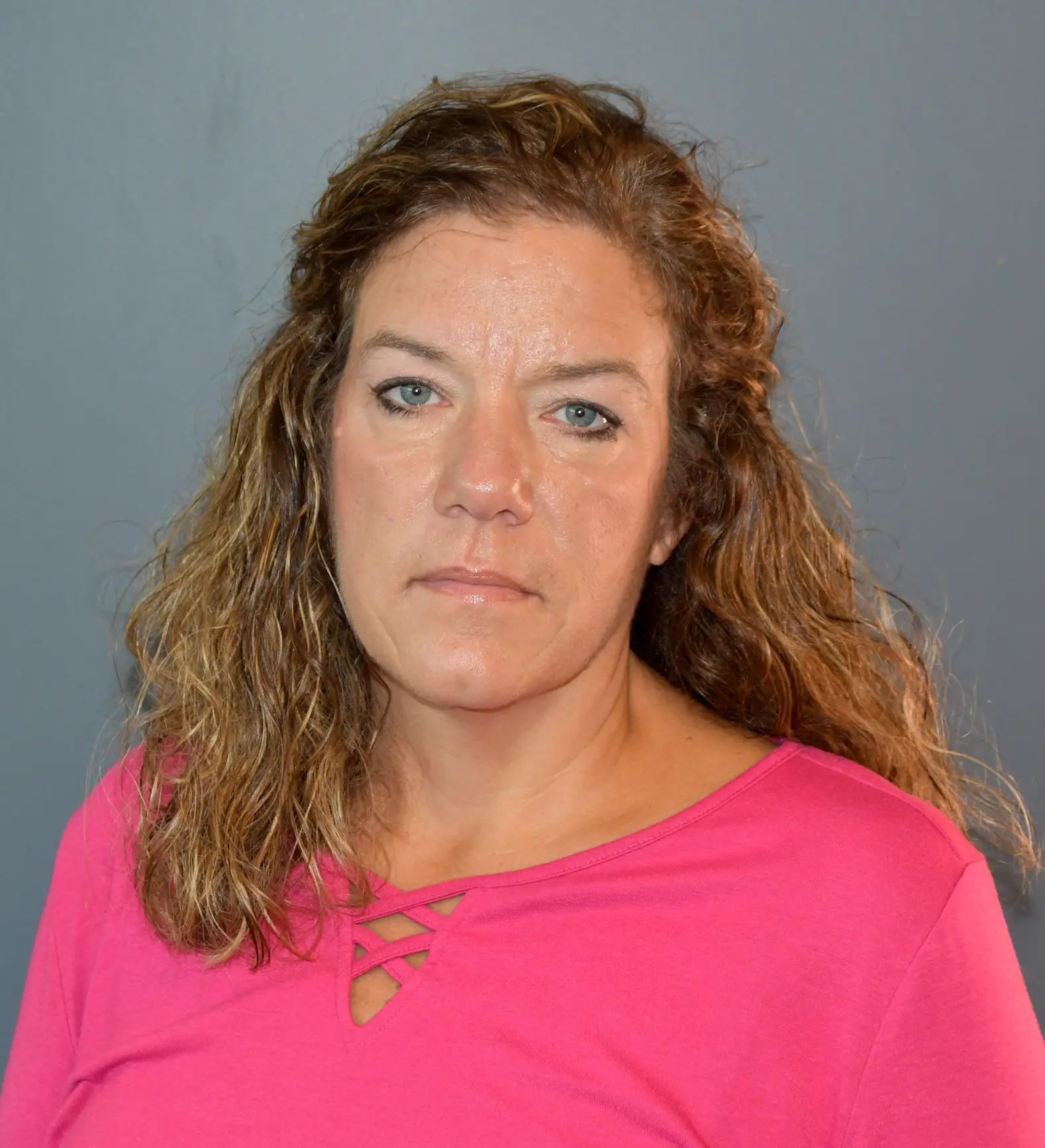 Professional headshot of Tammy Bonham wearing a pink top against a neutral background.