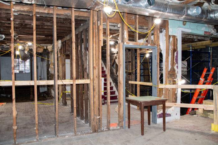The first floor of the Hotel Thelma building is under construction. Walls have been removed to reveal studs, wiring, and other systems.